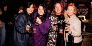 writer jo and 3 other women in a nighttime setting with drinks tulleys shocktoberfest