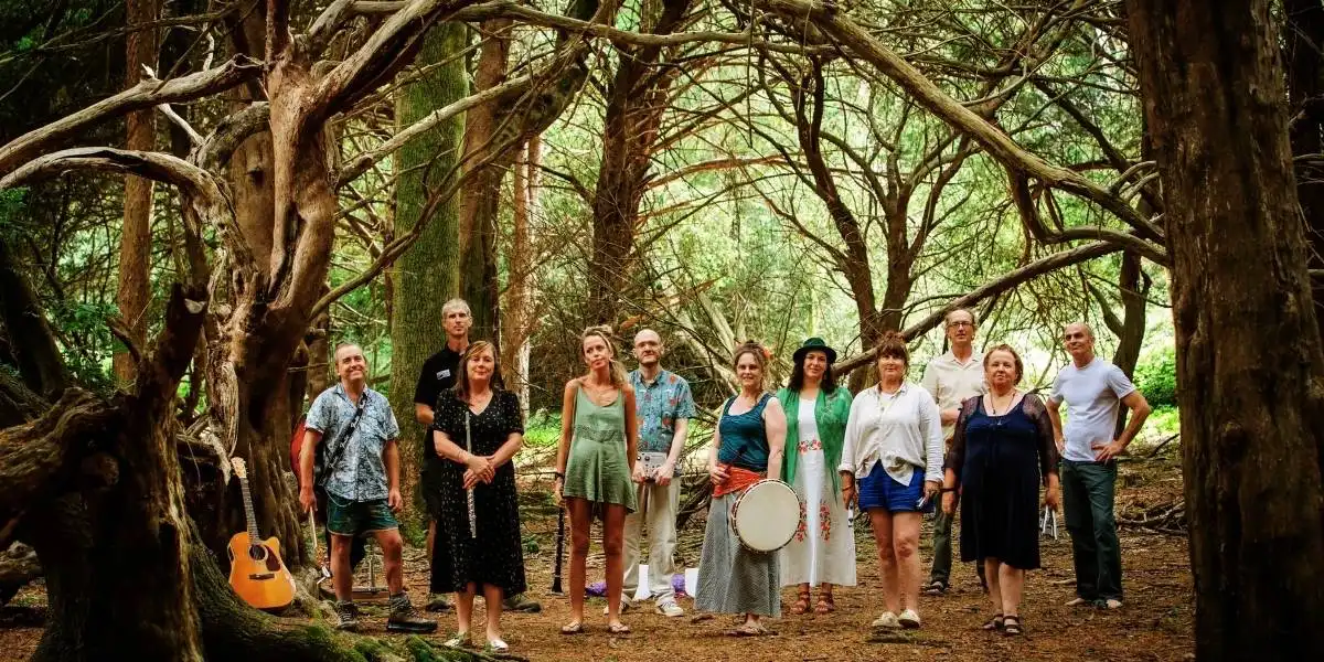 a group of musicians in a forest setting enchanting forest