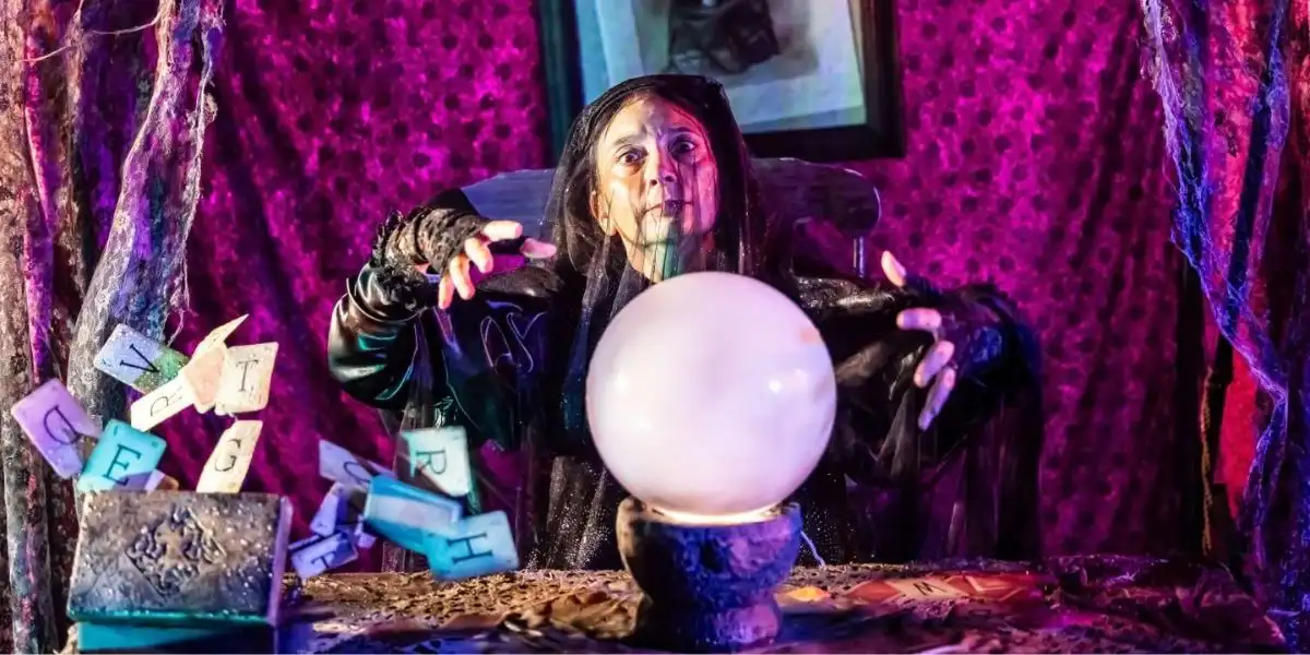 woman looking into a crystal ball halloween at blenheim palace