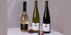 moderato low alcohol wine - 3 bottles on a table with some decorative grapes