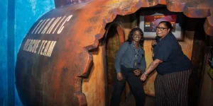 two people in a representation of a rusted out submarine