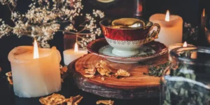 spooky season for big kids a cup of tea set on a piece of wood with leaves and autumnal flowers