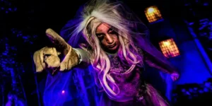 scary person at tulleys farm with a white wig and purple clothes spooky season for big kids