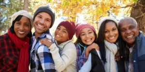 multi generational group of people in an outdoor autumn setting man and woman looking at a map - walking holidays