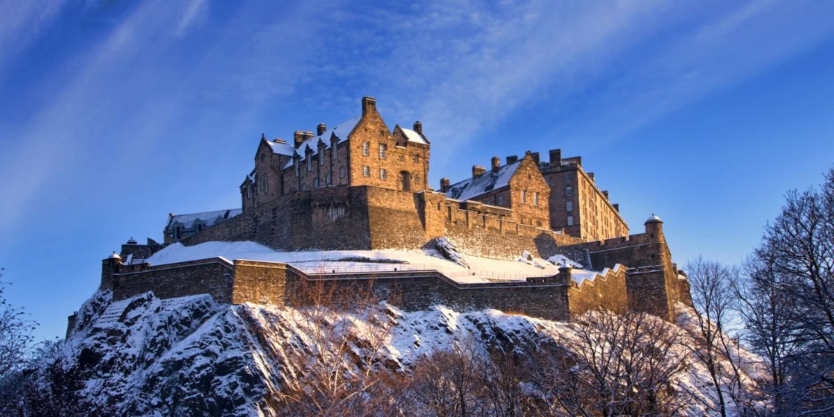 edinburgh castle on a hilltop in the snow winter holiday destinations