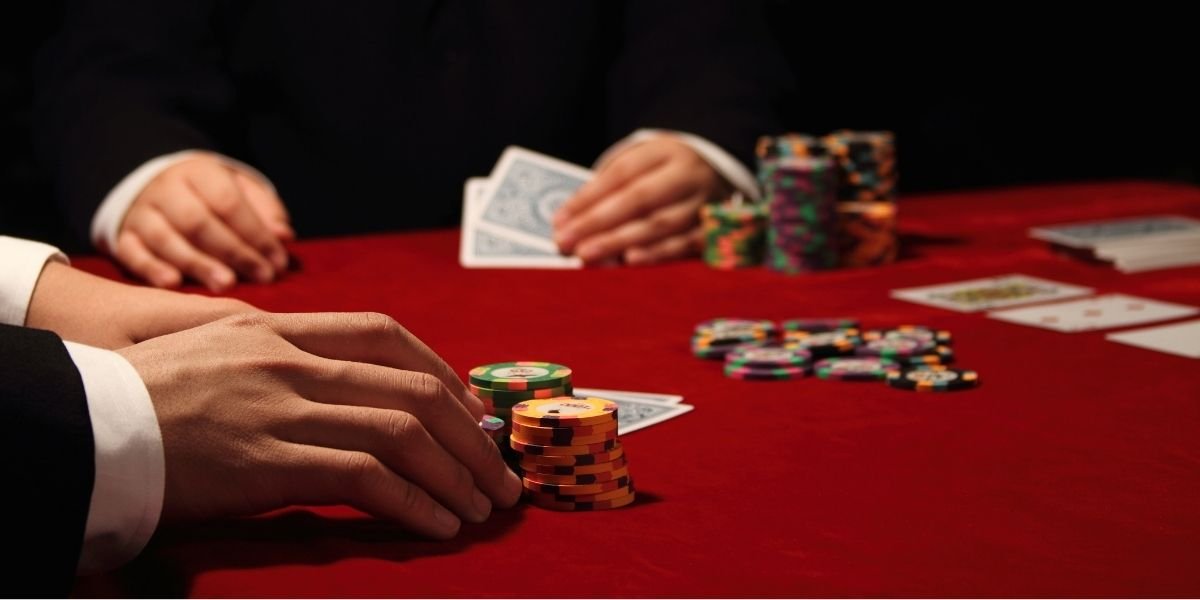 Image of high stakes poker game in progress. Both male players exude wealth, confidence and success. casino resort
