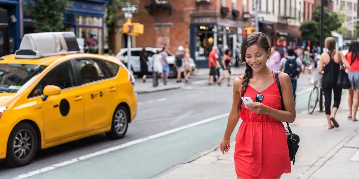 Woman walking in new york city using phone app playing online game while commuting from work.