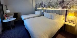 inside the hotel room, two large beds