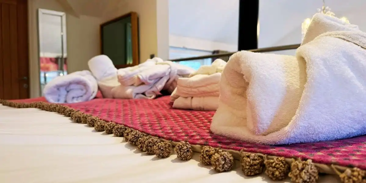 bedspread and rolled towels