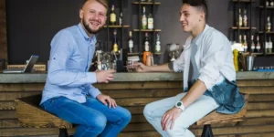two men sat at a counter enjoying a CBD drink