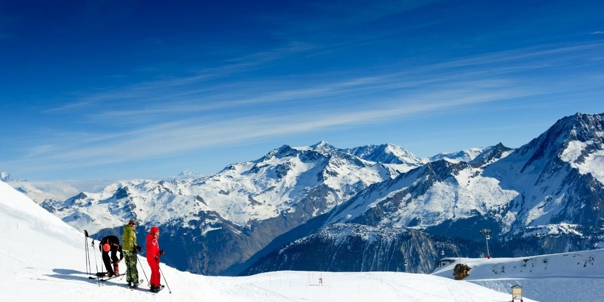 Ski slope. Skiers on the top of the mountain in Meribel Valley at French Alps
