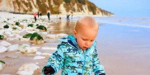small child wandering along the beach