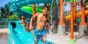 young child running through a colouful water park