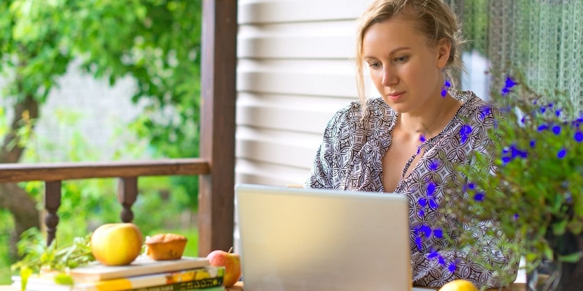 a writer at a table in a sunny window position