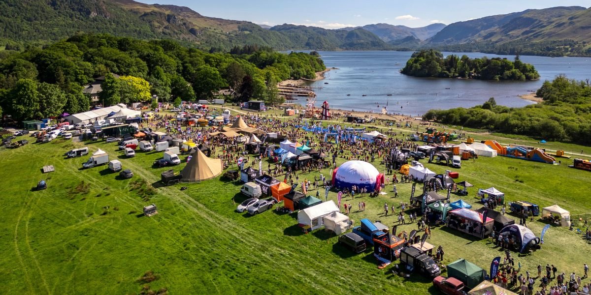 a campsite and festival ground next to a lake in keswick