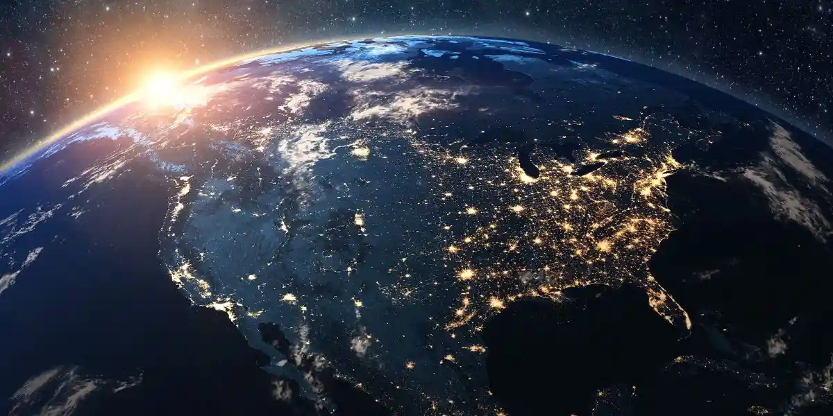 the sun aetting over the earth from space with North America shown