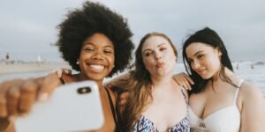 three women taking a selfie on the beach
