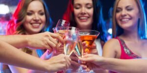 women toasting with cocktails. cheers