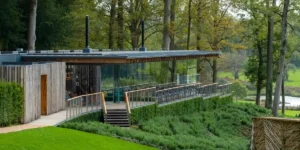 glass fronted building in a forest