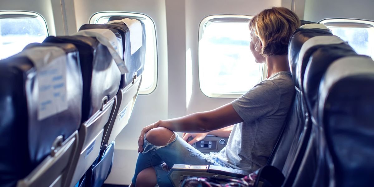 travel by flight, woman tourist sitting in air plane. Travel concept