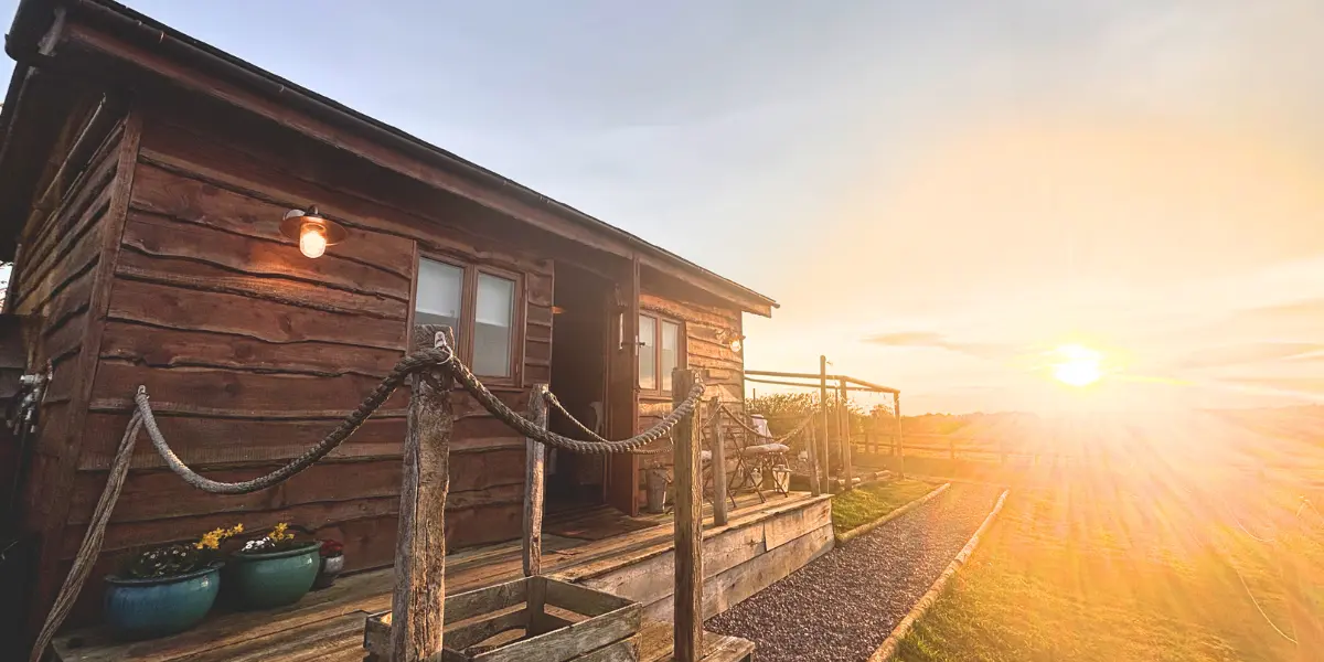 a wooden lodge at sunset