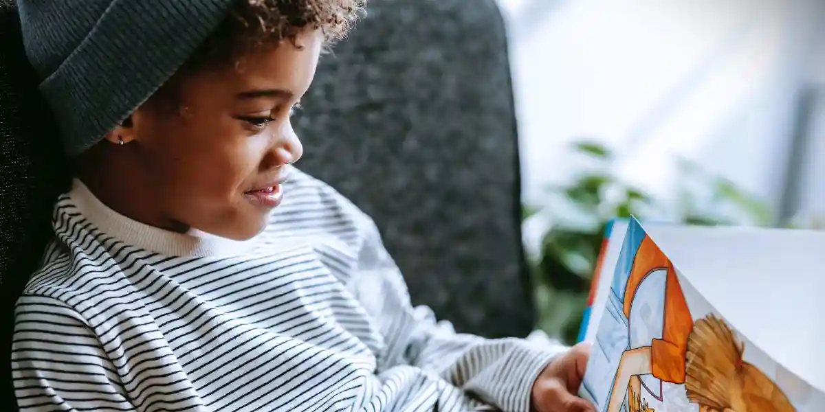 Eldon Square launches Easter Reading Corner young boy reading a book on comfy sofa