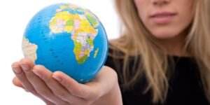 Global business concept with a globe and businesswoman