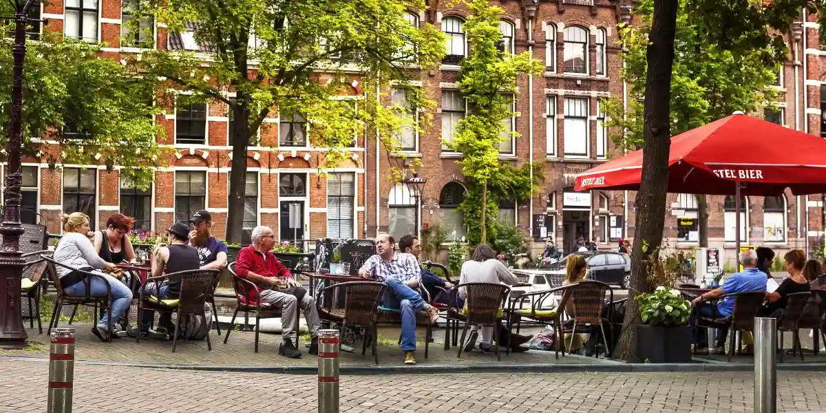 a cafe in amsterdam where people are relaxing with coffee
