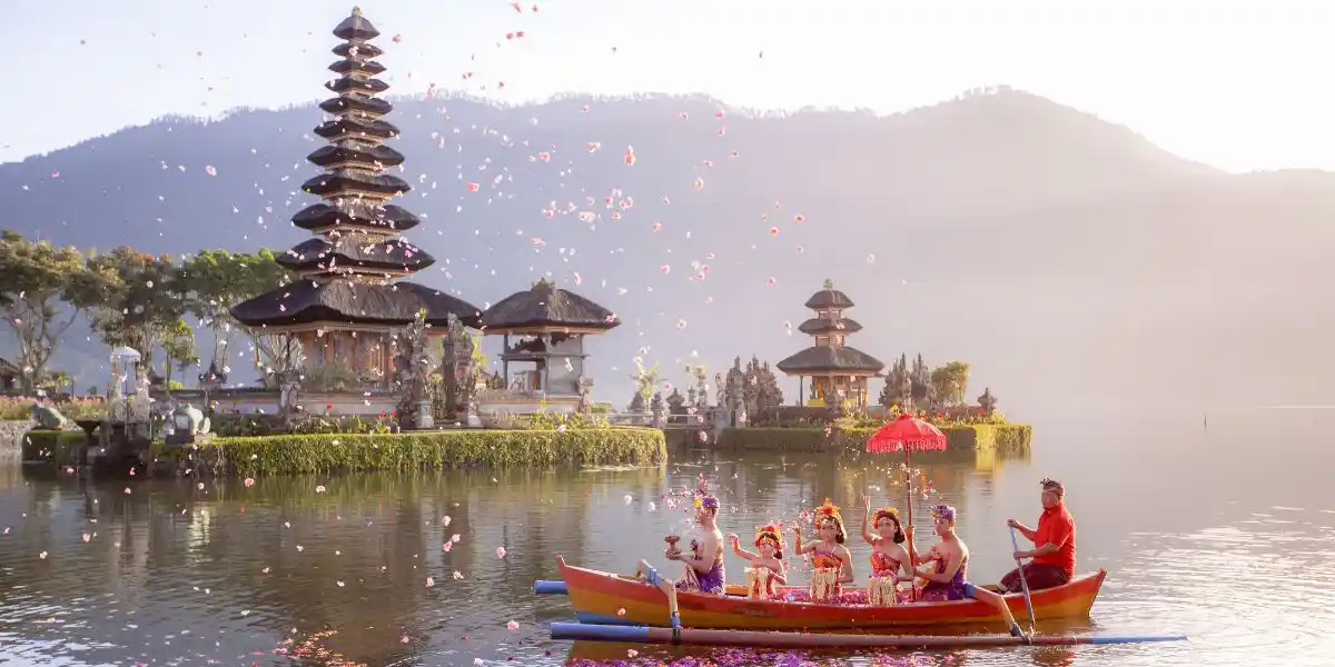 Balinese villagers participating in traditional religious Hindu procession in Ulun Danu temple Beratan Lake in Bali Indonesia