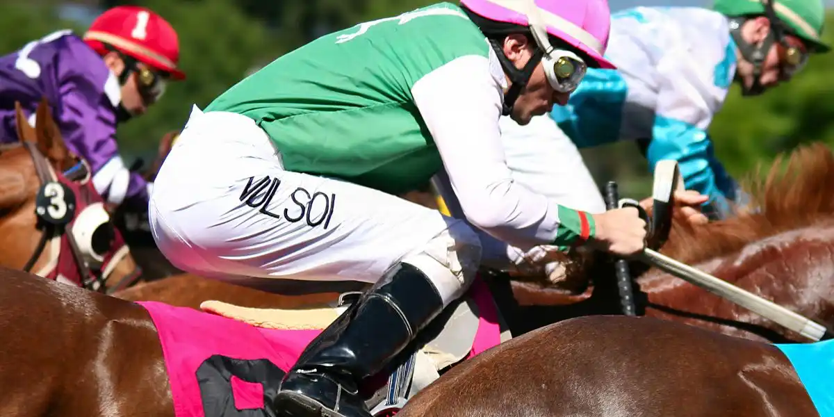 Jockeys at full gallop. Action shot of jockeys in horse rac