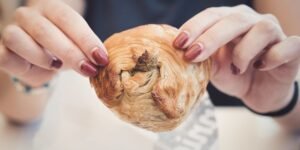 Woman hands with Traditional savoury pastry baking delicacy Pastizzi from Malta street food