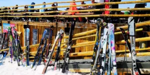 skis propped up outside a hut on a snowy mountainside