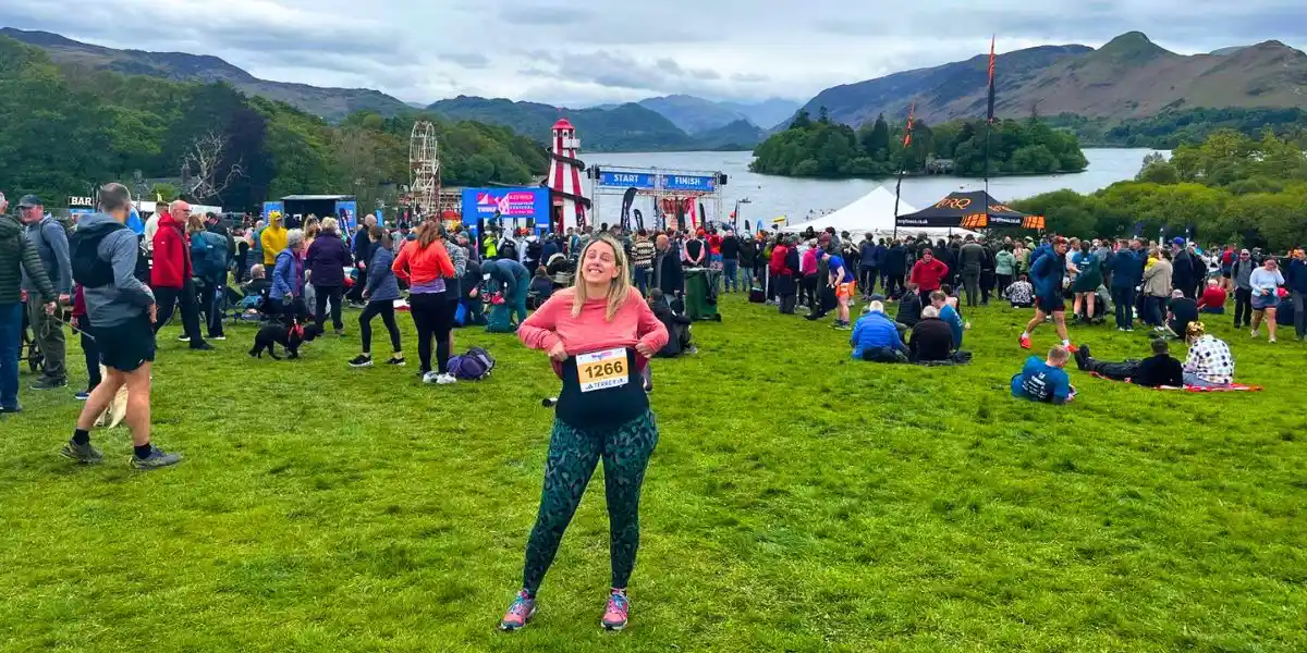 woman standing in an event field with a medal