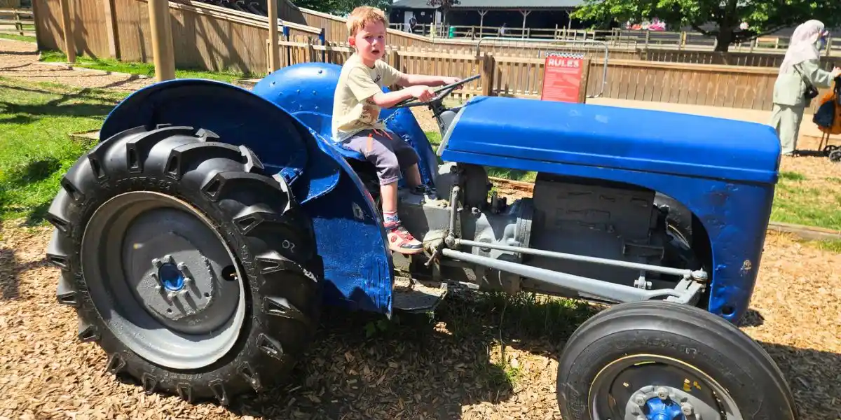 child playing on a toy tractor at mead farm