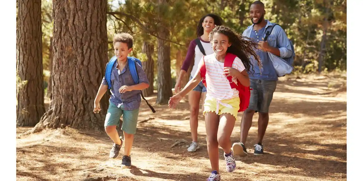 an active family run through a forest