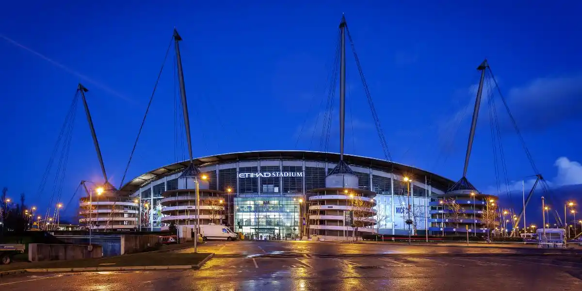 Manchester City Football Club is an English Premier League football club based in Manchester. night time view of their stadium