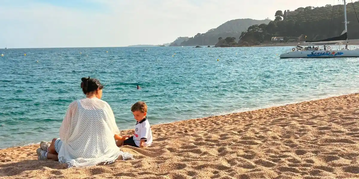 woman and young child on a beach enjoying themselves