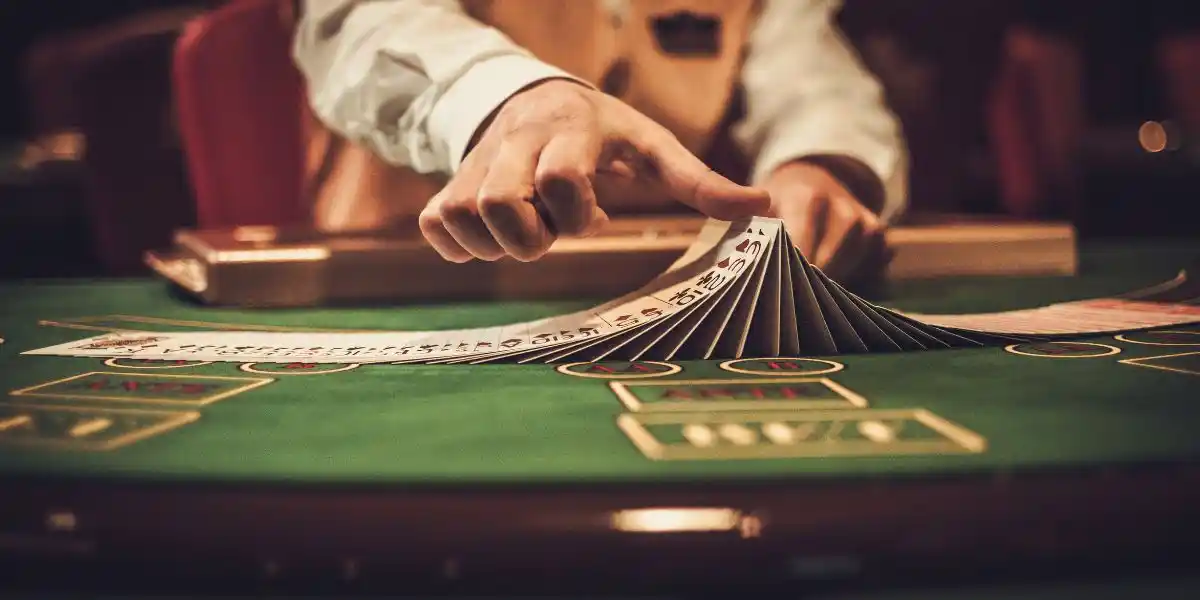 a card table with the dealer moving cards