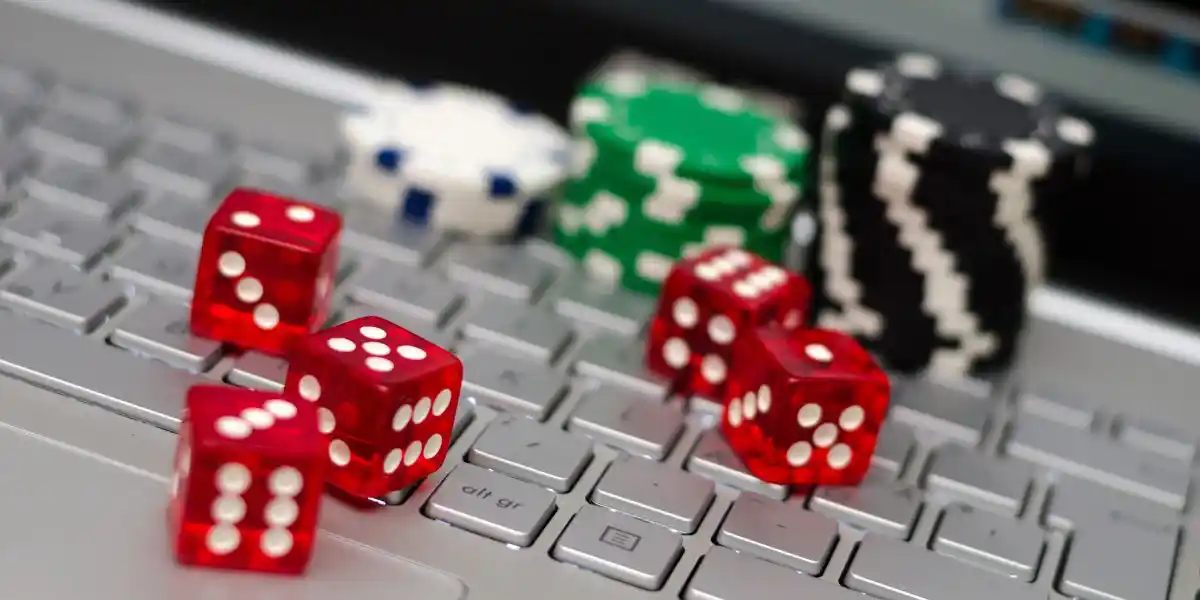 dice, casino chips on a keyboard, concept of risk