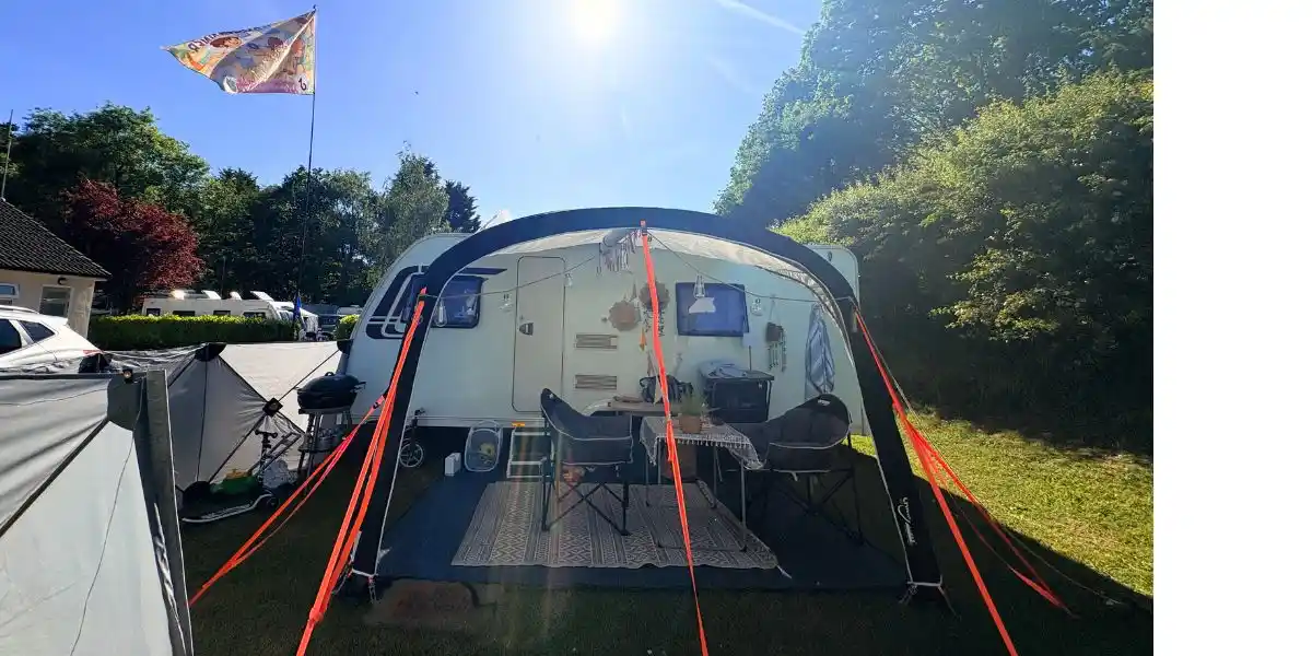 a caravan and awning in an outdoor setting