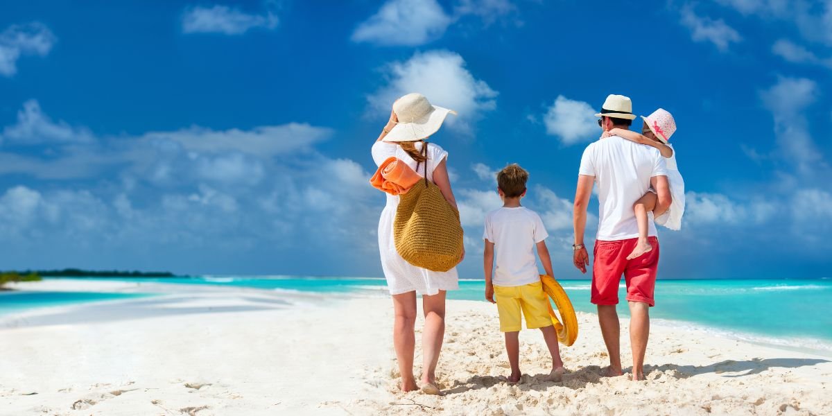family on a beach after successfully palnning their holiday