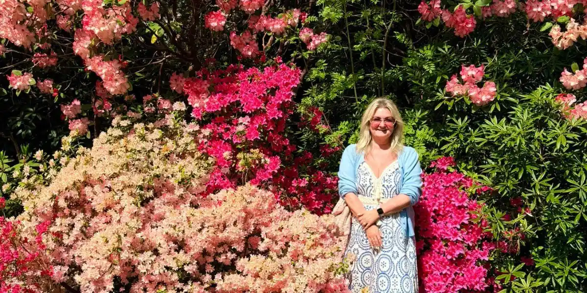 Sarah in front of beautiful flowers in the new forest