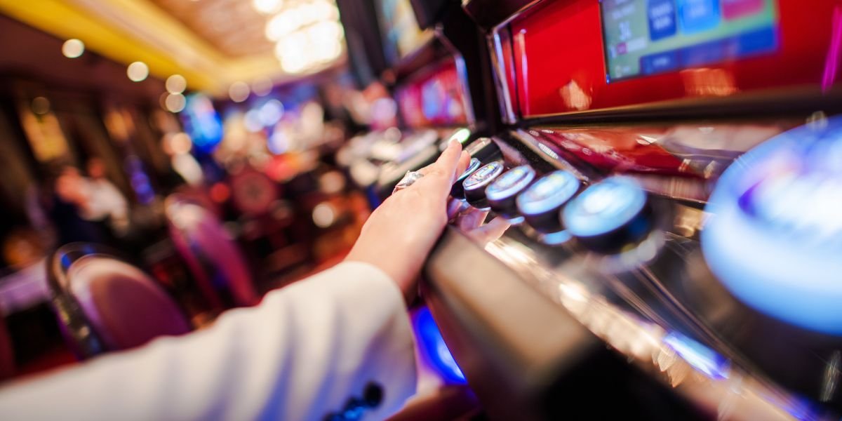 slot machines with a hand pressing a button