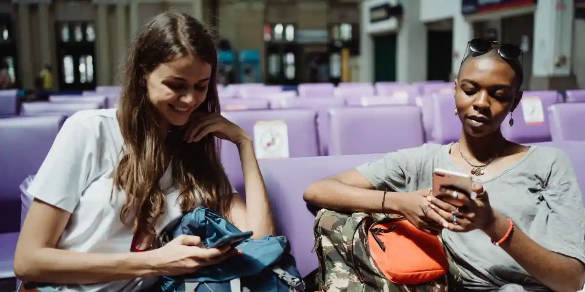 two women in an airport lounge travel entertainment concept