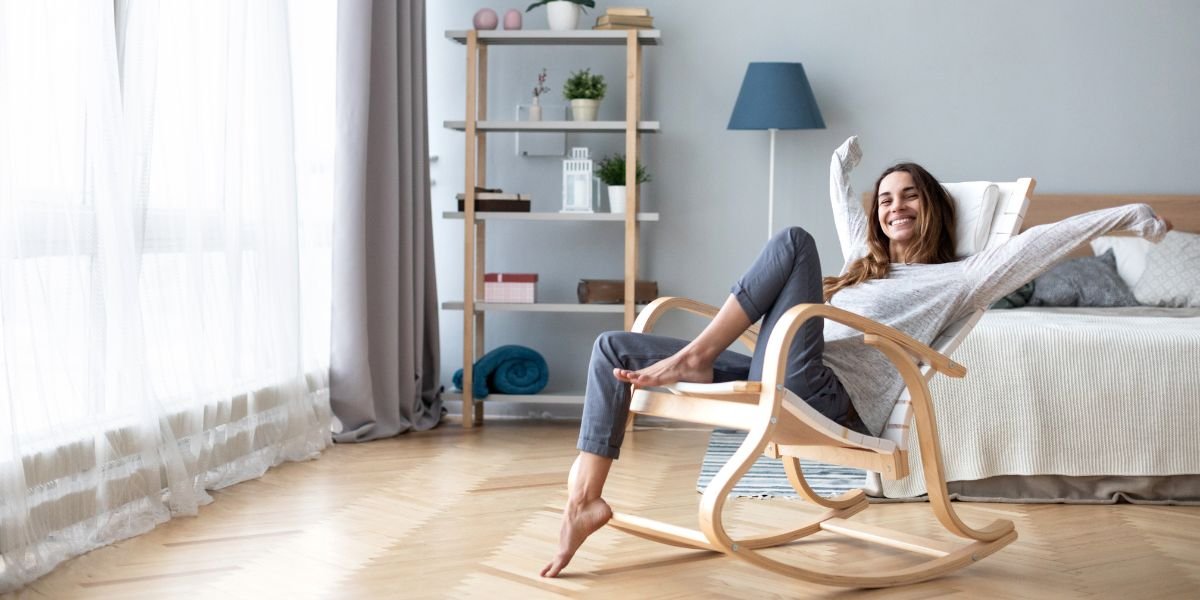 Woman joyfully lounging in the living room in comfort because of the smart humidifier