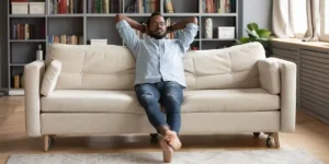 Man relaxing on the sofa in comfort because of the smart humidifier