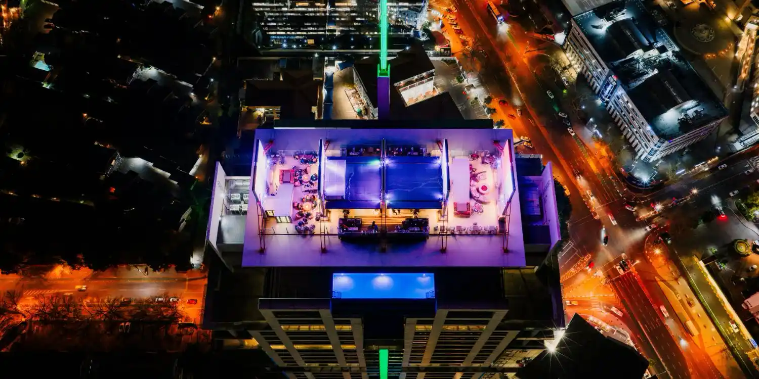 a rooftop bar in the evening in a new city