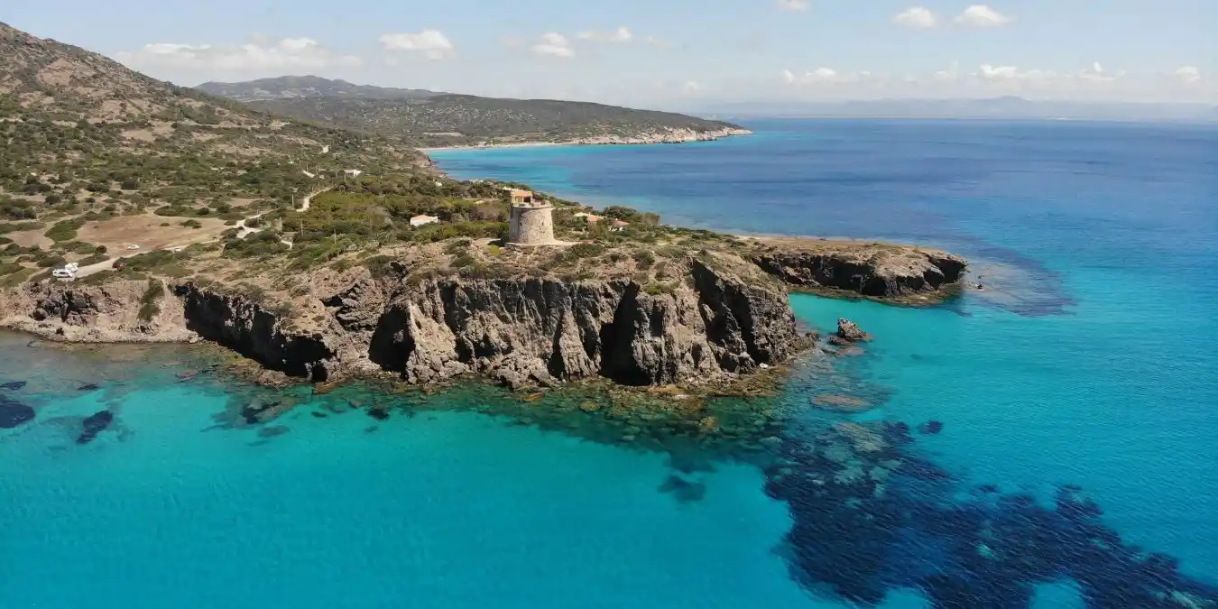 Stunning coastal view of Torre Cannai and crystal blue waters in Sardinia, Italy. Good place for a road trip