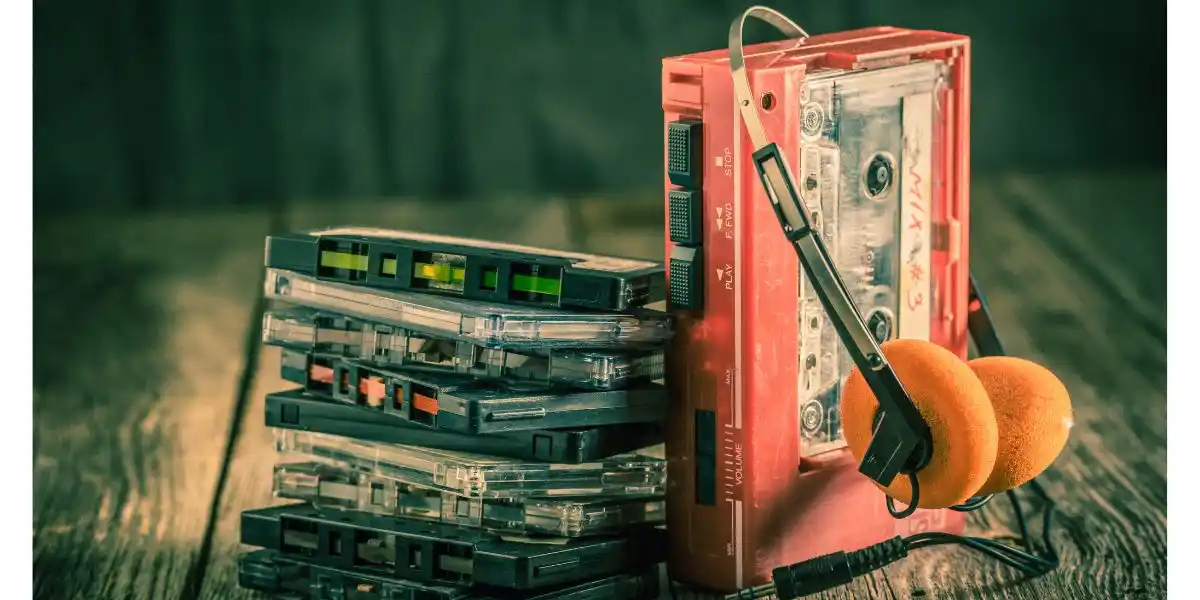 Closeup of antique cassette tape with headphones and walkman. travel gaming