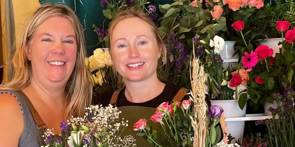 Kate and a florist with some flowers at the big retreat